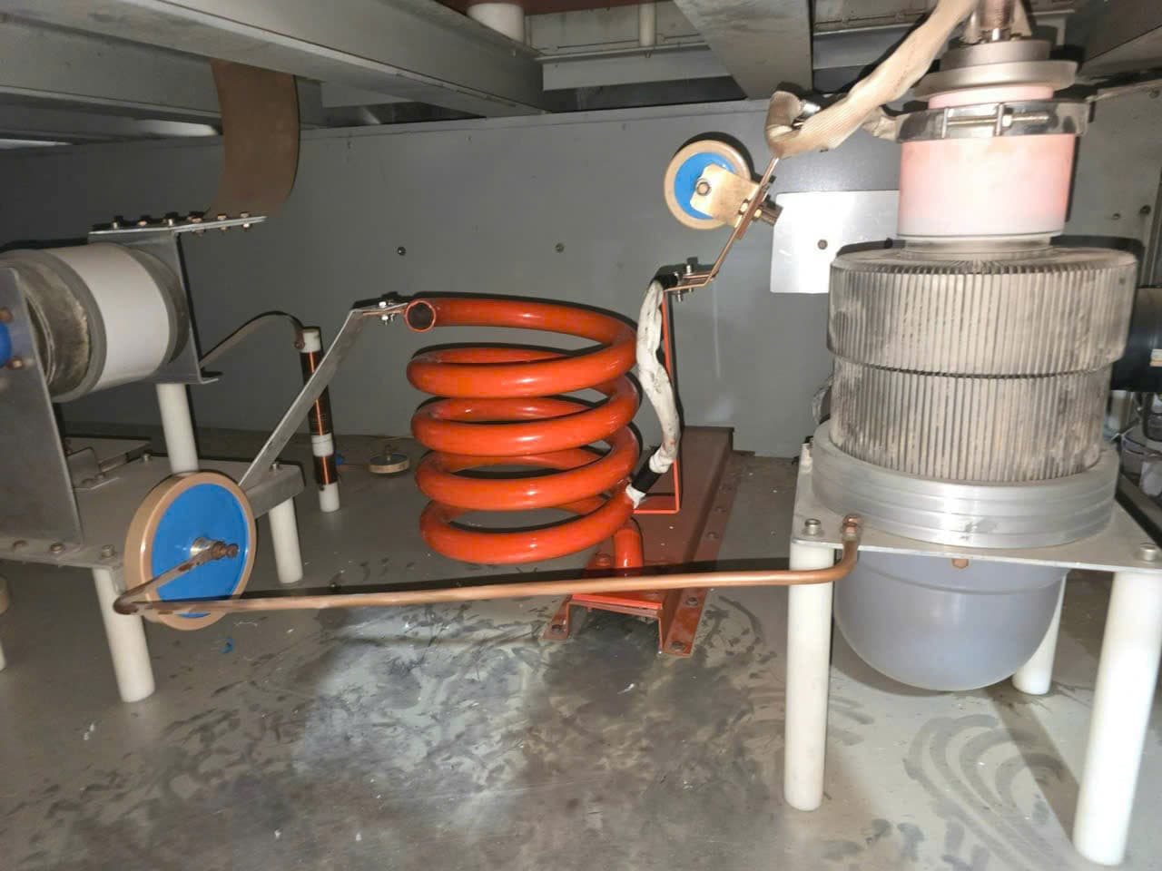 Service technicians checking a machine control panel with diagnostic tools.